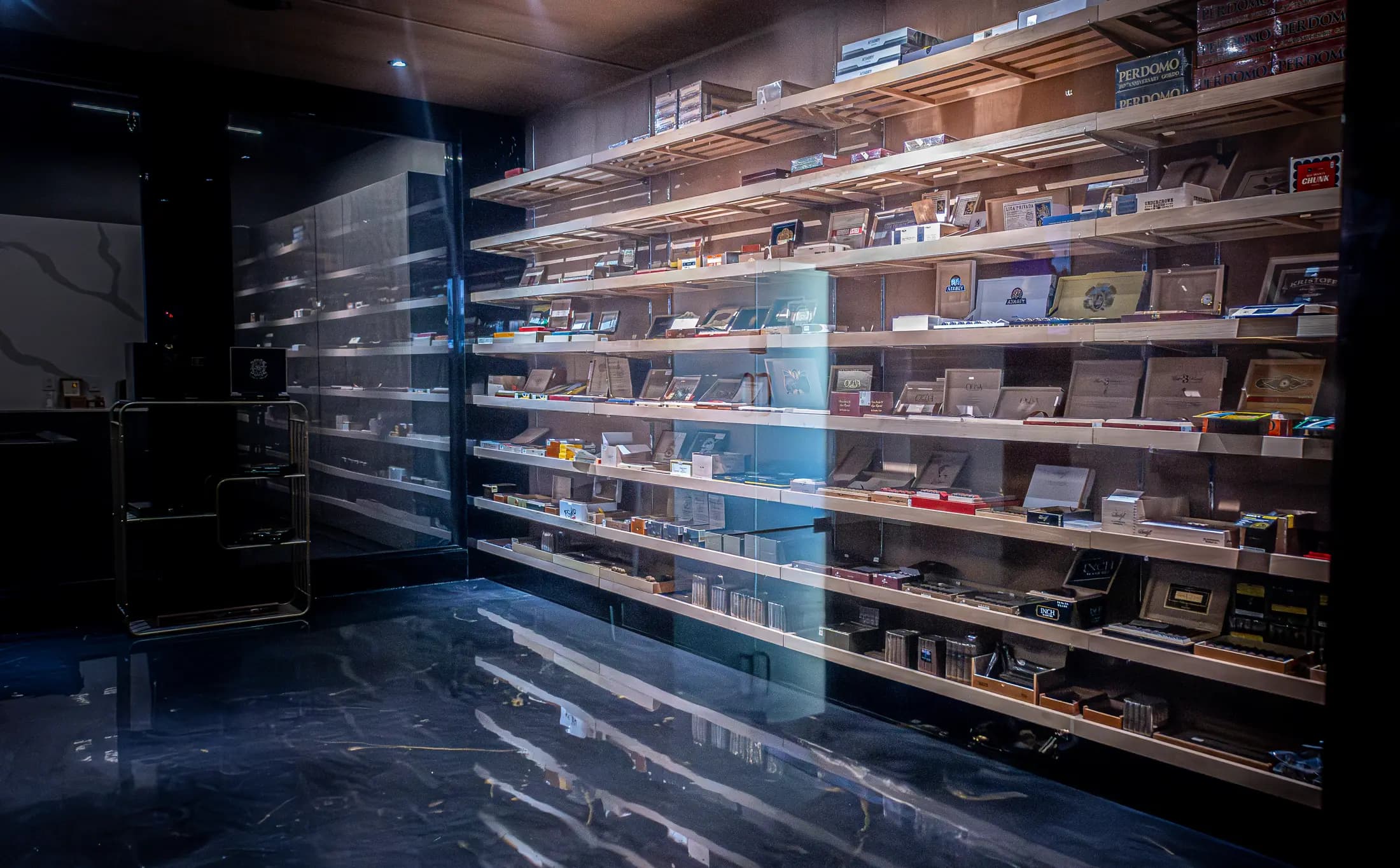 The walk-in humidor, lit shelf by shelf